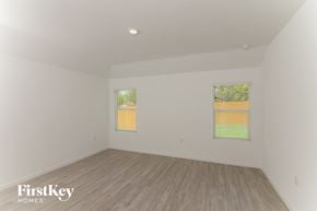 San Antonio house for rent - the living room of a house with wood floors and white walls