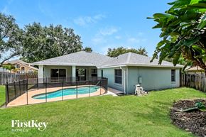 Valrico house for rent - a backyard with a swimming pool and a house