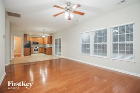 Summerville house for rent - A spacious room with a ceiling fan and wooden flooring.