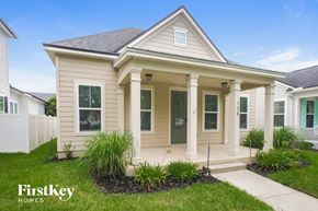 St Johns house for rent - a beige house with white pillars and a sidewalk