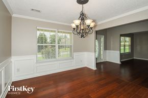 Dallas house for rent - an empty dining room with a large window and a chandelier