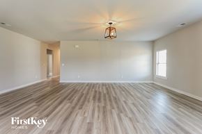 Jemison house for rent - A room with wooden flooring and a light fixture hanging from the ceiling.
