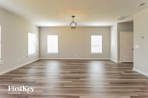 Jemison house for rent - an empty living room with wood floors and a light fixture