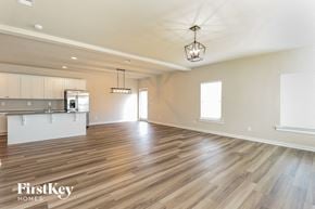 Jemison house for rent - an empty living room and kitchen with wood flooring