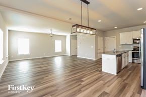 Jemison house for rent - an empty kitchen and living room with wood flooring