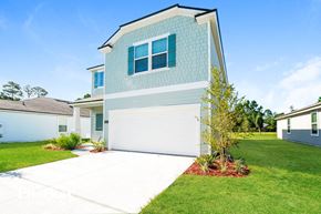 St Augustine house for rent - A house with a white garage door and a blue wall.