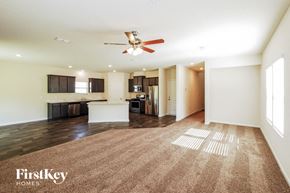 St Augustine house for rent - A spacious room with a carpeted floor and a ceiling fan.