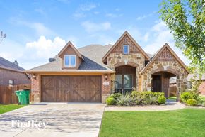Waxahachie house for rent - a house with a driveway and a garage door