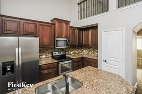 Waxahachie house for rent - the kitchen has granite counter tops and stainless steel appliances