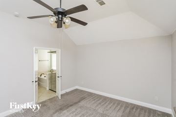 Waxahachie house for rent - a living room with a ceiling fan and a rug