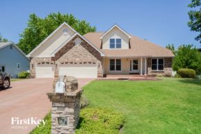 Lake St. Louis house for rent - A house with a stone pillar in front of it.