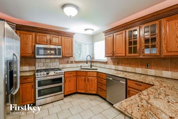 Lake St. Louis house for rent - A kitchen with wooden cabinets and granite countertops.