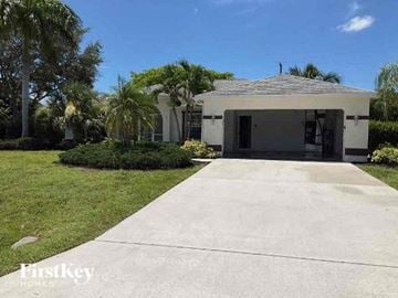 Cape Coral house for rent - a house with a driveway and a garage door