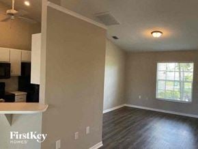 Cape Coral house for rent - an empty room with a kitchen and a window