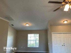 Cape Coral house for rent - an empty room with a ceiling fan and a white door