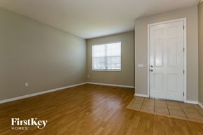 Riverview house for rent - A room with wooden flooring and a white door.