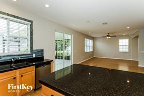 Riverview house for rent - A kitchen with a black granite countertop and wooden cabinets.