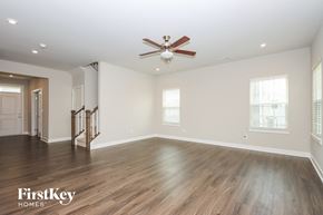 Denver house for rent - A spacious room with a ceiling fan and wooden flooring.