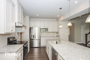 Denver house for rent - A modern kitchen with granite countertops and stainless steel appliances.