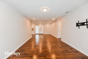 Garland house for rent - A room with wooden floors and white walls.