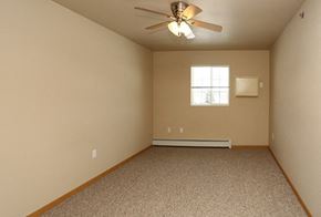 Manitowoc apartment for rent - an empty room with a ceiling fan and a window