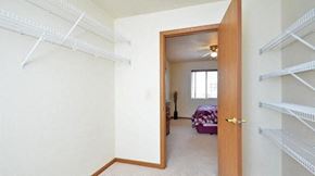 Manitowoc apartment for rent - an empty closet in a bedroom with a bed