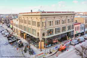 Manitowoc apartment for rent - a crane is parked outside of a building on a city street