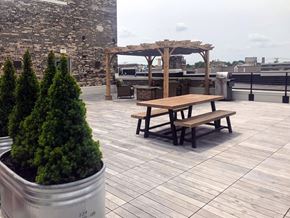 Manitowoc apartment for rent - a picnic table on a roof terrace with a pergola