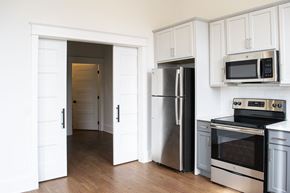 Manitowoc apartment for rent - a kitchen with stainless steel appliances and white cabinets