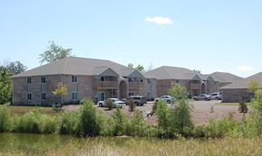 De Pere apartment for rent - a building with cars parked in front of it