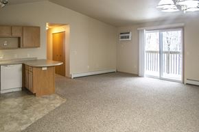 De Pere apartment for rent - an empty kitchen and living room with a door to a balcony