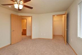 De Pere apartment for rent - an empty bedroom with two doors and a ceiling fan