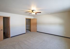 Sheboygan Falls apartment for rent - a empty living room with a ceiling fan and a closet