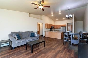 Sheboygan Falls apartment for rent - a living room and kitchen with a couch and a ceiling fan