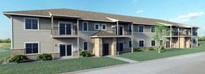 Sheboygan Falls apartment for rent - a large apartment building with a sidewalk and grass