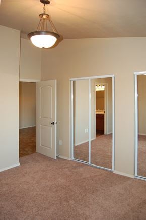 Hobart apartment for rent - an empty living room with a mirror and a door to a bathroom
