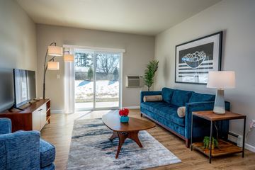 Sturgeon Bay apartment for rent - a living room with a blue couch and a coffee table