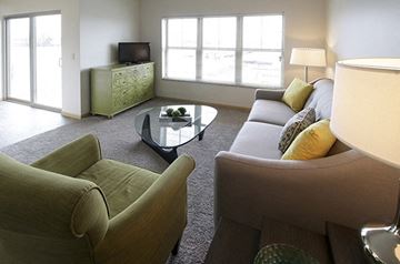 Oshkosh apartment for rent - a living room with couches and chairs and a television
