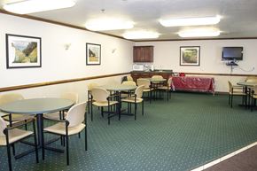 Sturgeon Bay apartment for rent - a dining room with tables and chairs and a kitchen in the background