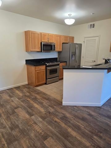 Reno apartment for rent - A kitchen with wooden cabinets and a black countertop.