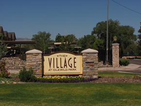 Reno apartment for rent - A sign that says "The Village at Idlewild Park" is in front of a building.