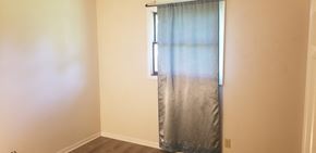 Wilmington apartment for rent - an empty room with a window with a curtain and a white wall