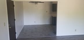 Wilmington apartment for rent - an empty living room with a ceiling fan and a tiled floor