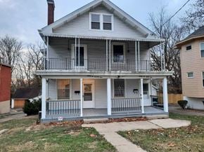 Cincinnati house for rent - a white house with a porch and a sidewalk