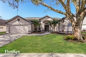Wesley Chapel house for rent - a house with palm trees in front of it
