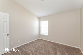 Wesley Chapel house for rent - a spacious bedroom with carpeted flooring and a window