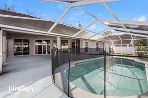 Wesley Chapel house for rent - a swimming pool in the middle of a house with a glass fence
