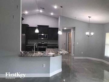 Lehigh Acres house for rent - a kitchen with a marble counter top in a house