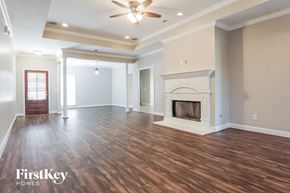 Chelsea house for rent - A spacious living room with wood flooring and a fireplace.