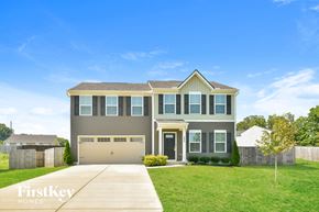 La Vergne house for rent - a house with a garage door and a lawn